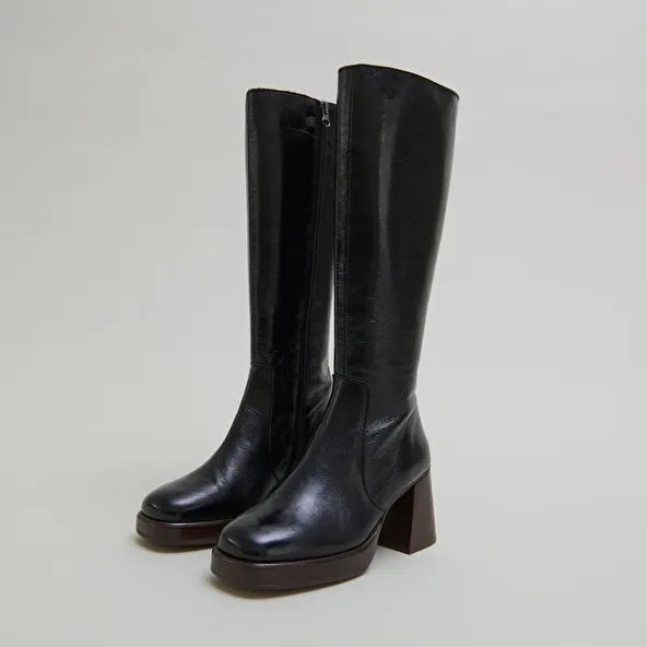 Platform boots in distressed black leather